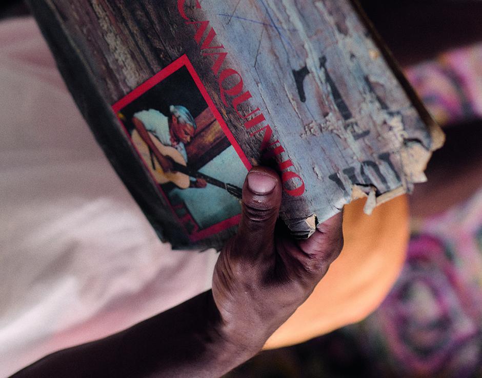 Caxtrinho holding a Nelson Cavaquinho album (see page 28 inside The Wire 493). Photo by Bruno Machado